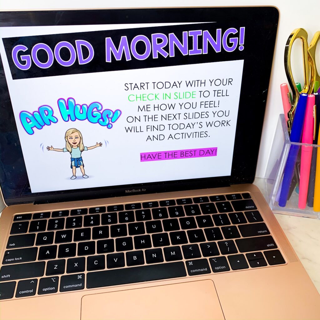 Open laptop displaying a morning greeting with a Bitmoji